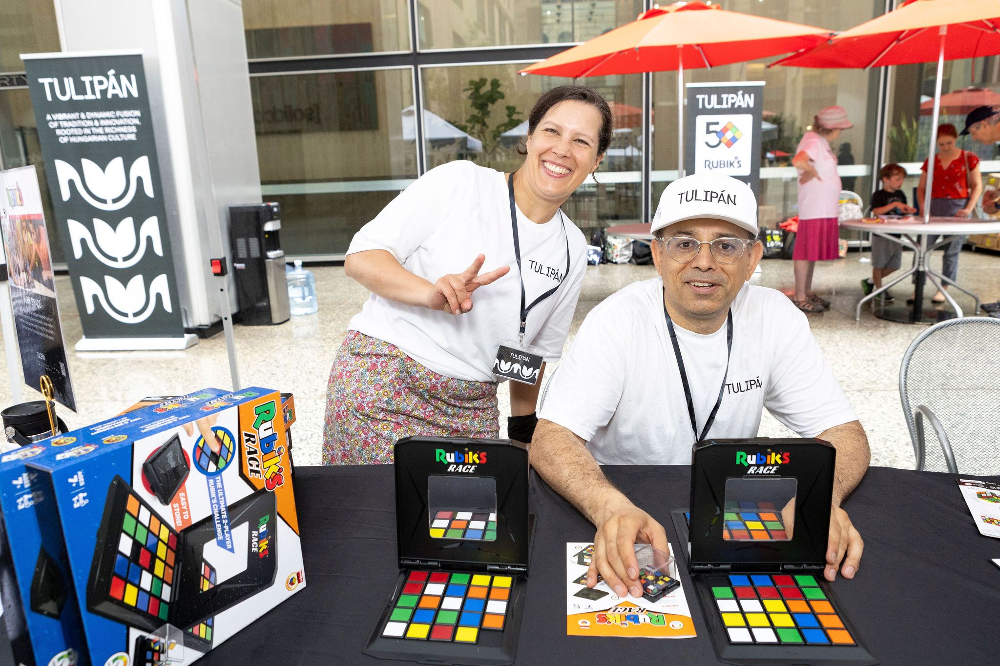 man and woman posing in front of games