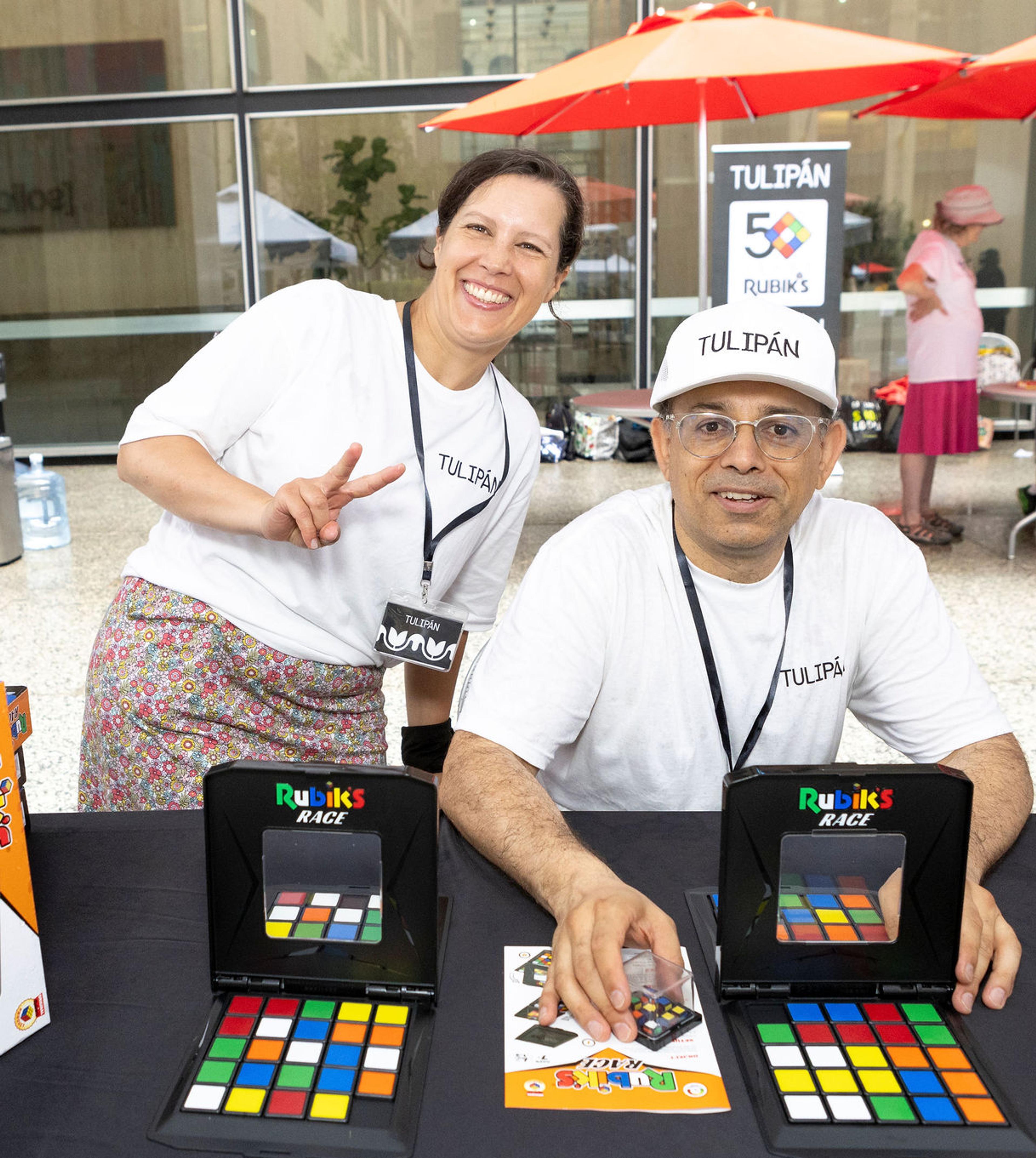 man and woman posing in front of games