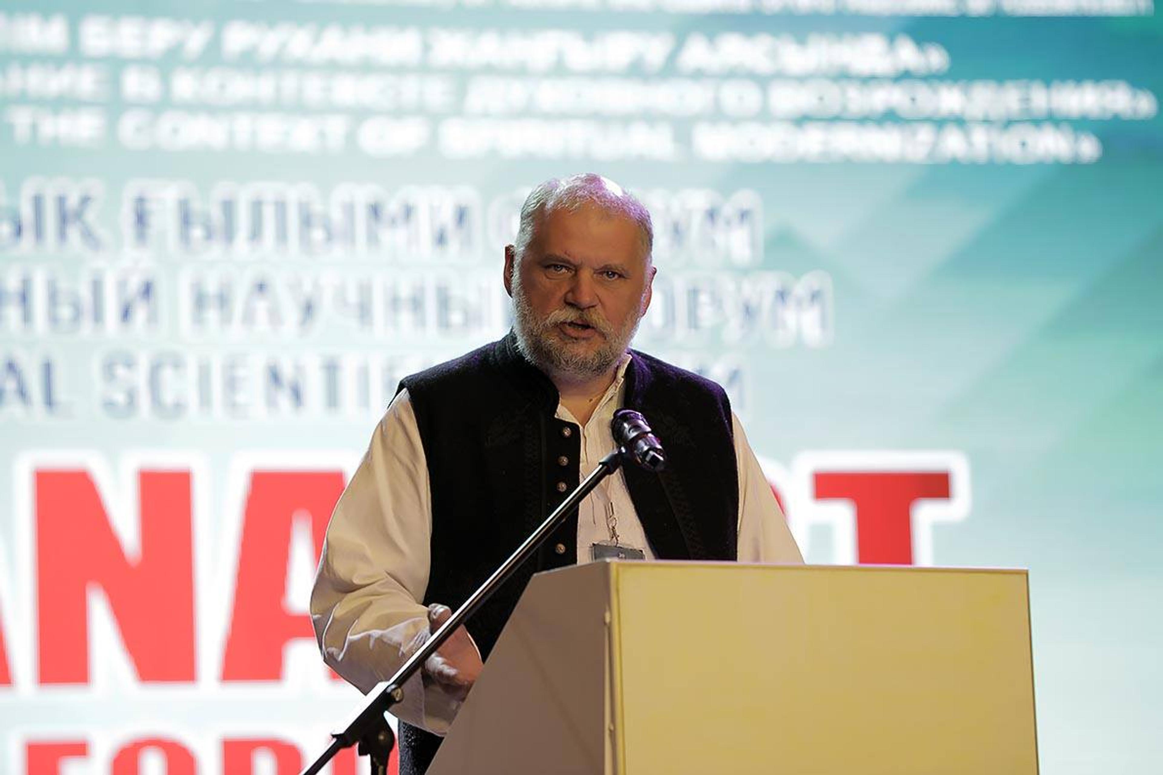 man speaking at a podium