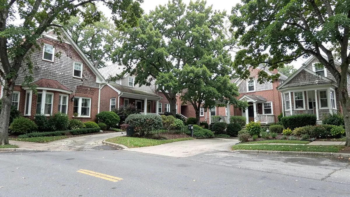 Cape and colonial homes on a residential street near the Nassau and Queens line in New Hyde Park, NY, Nassau County