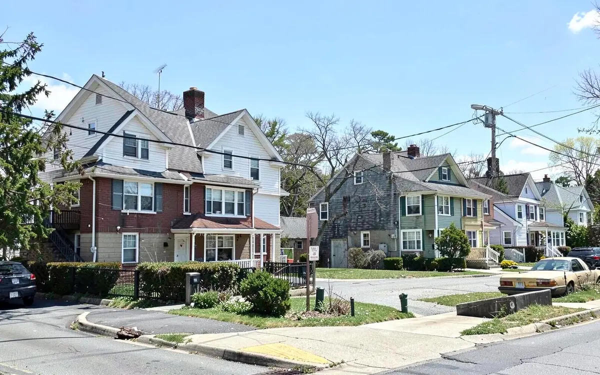 Two-family and cape homes on a residential block near the train station in Hicksville, NY, Nassau County