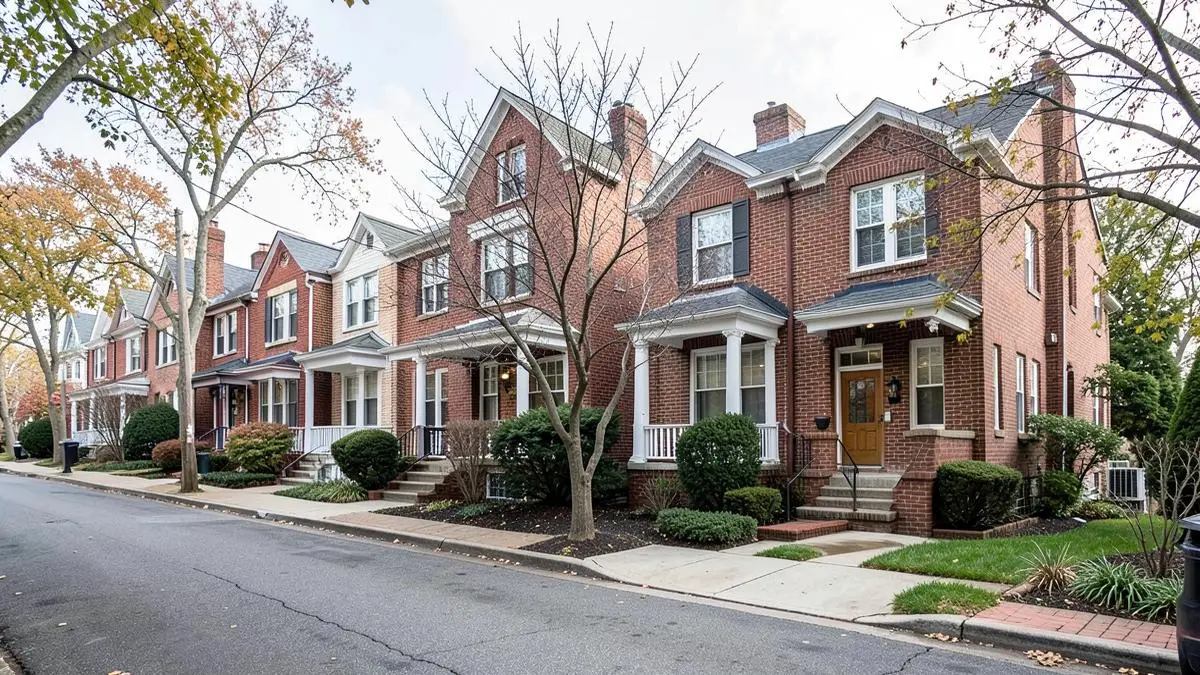 Attached and semi-detached brick homes on a residential street off Broadway in Elmhurst, Queens, NY