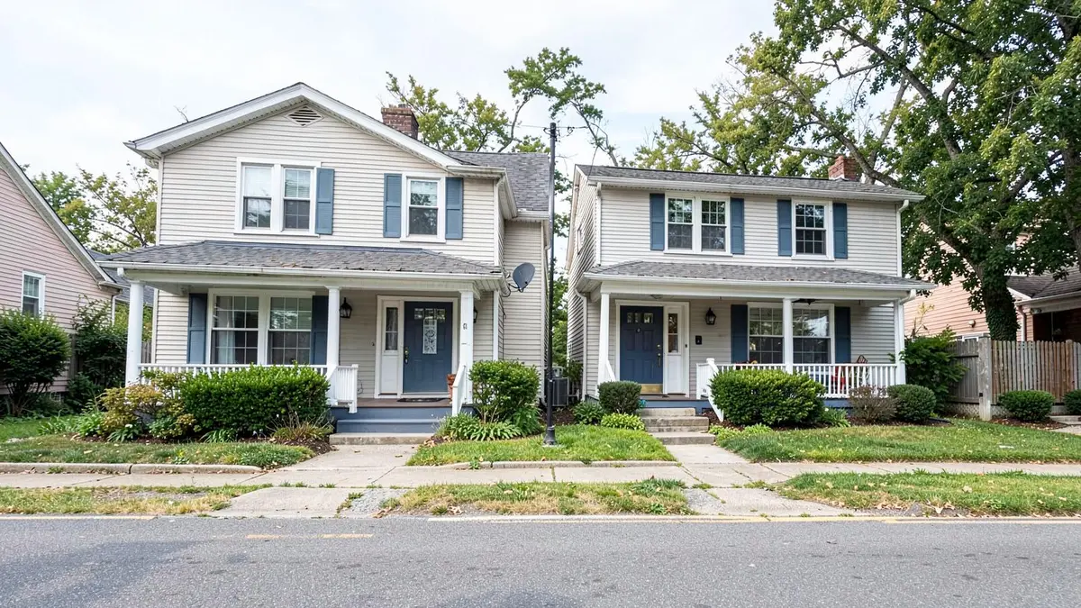 Two-family home with separate entrances on a residential street in Copiague, NY