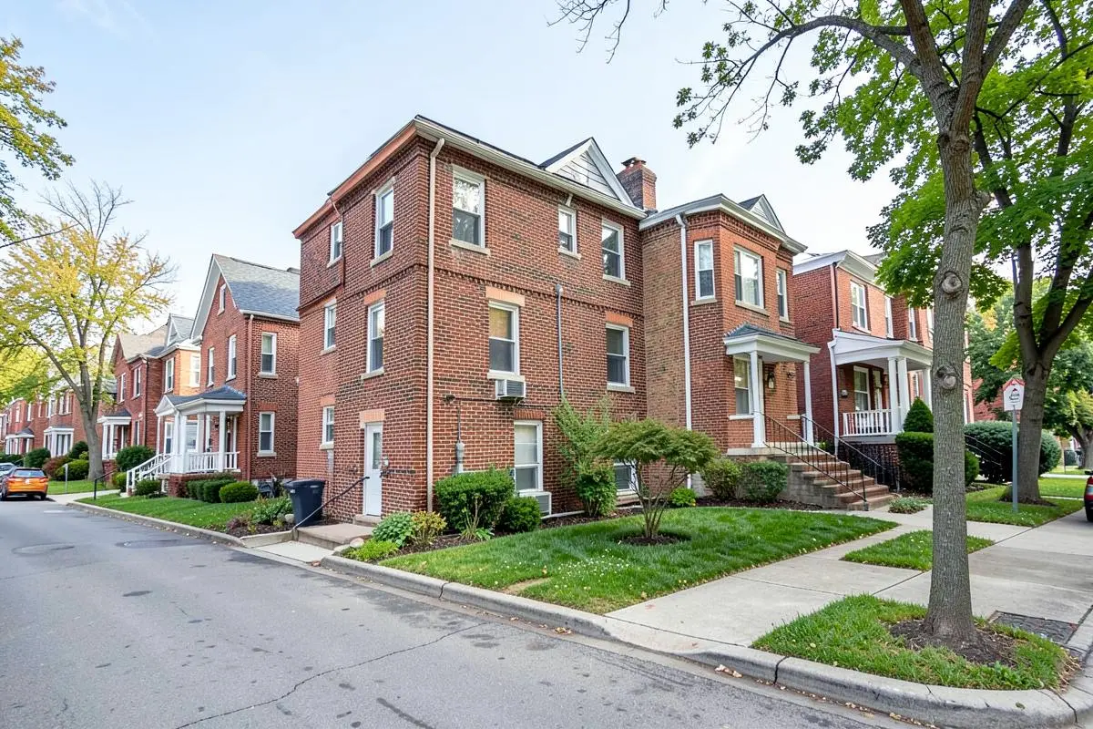 Detached and attached brick homes with small lawns on a residential street in Baychester, Bronx, NY