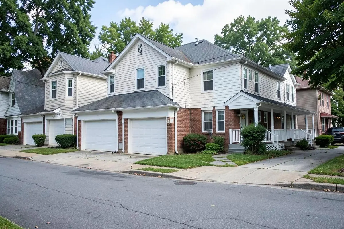 Detached two-story homes with attached garages on a residential street in Eltingville, Staten Island, NY
