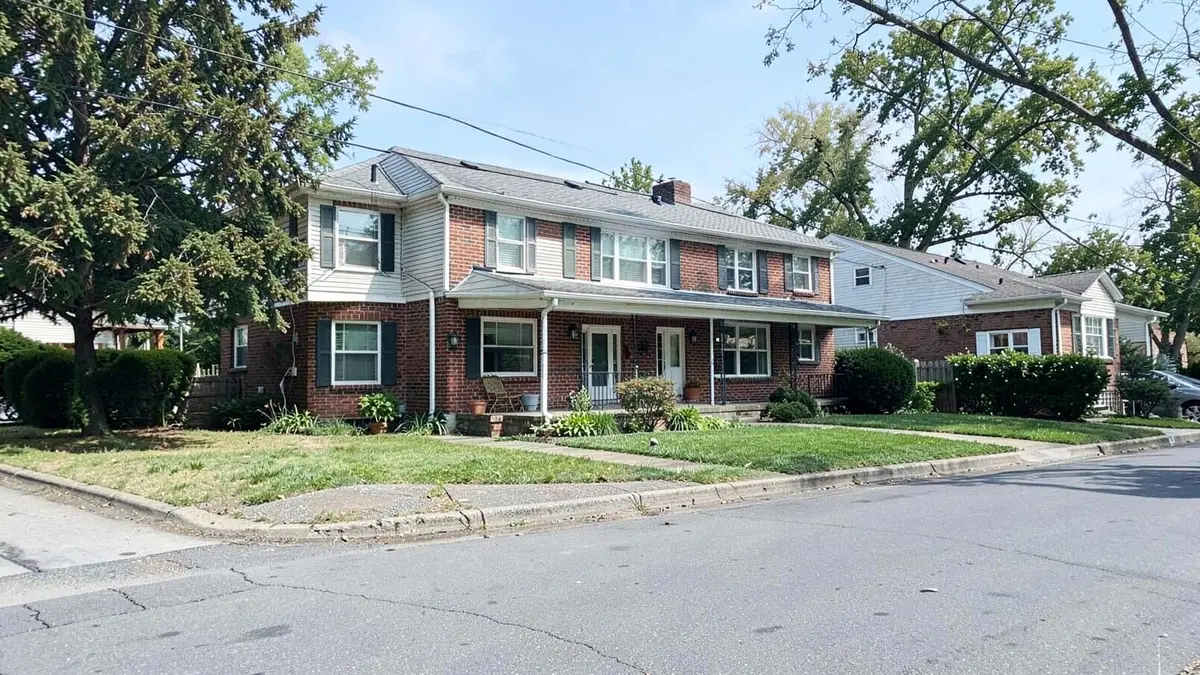 Brick and frame home on a residential street in Elmont, NY near the Queens border