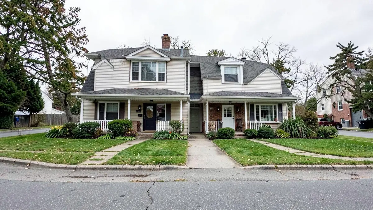Two-family home with separate entrances on a residential street in Hempstead, NY