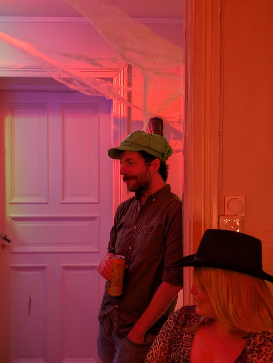 a man in a green hat is standing next to a woman in a black hat