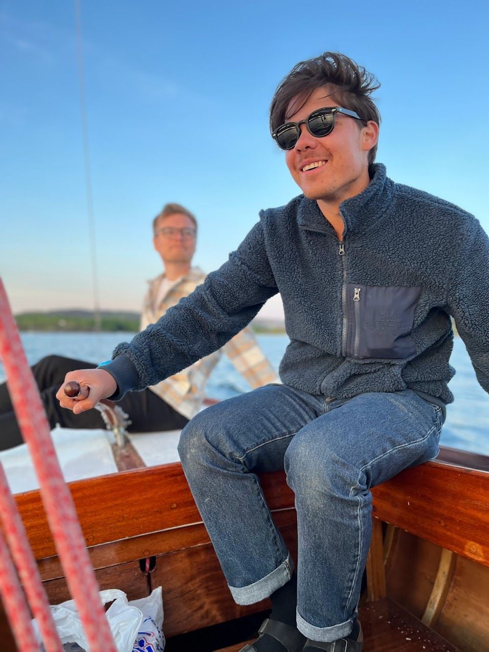 a man wearing sunglasses is sitting in a boat