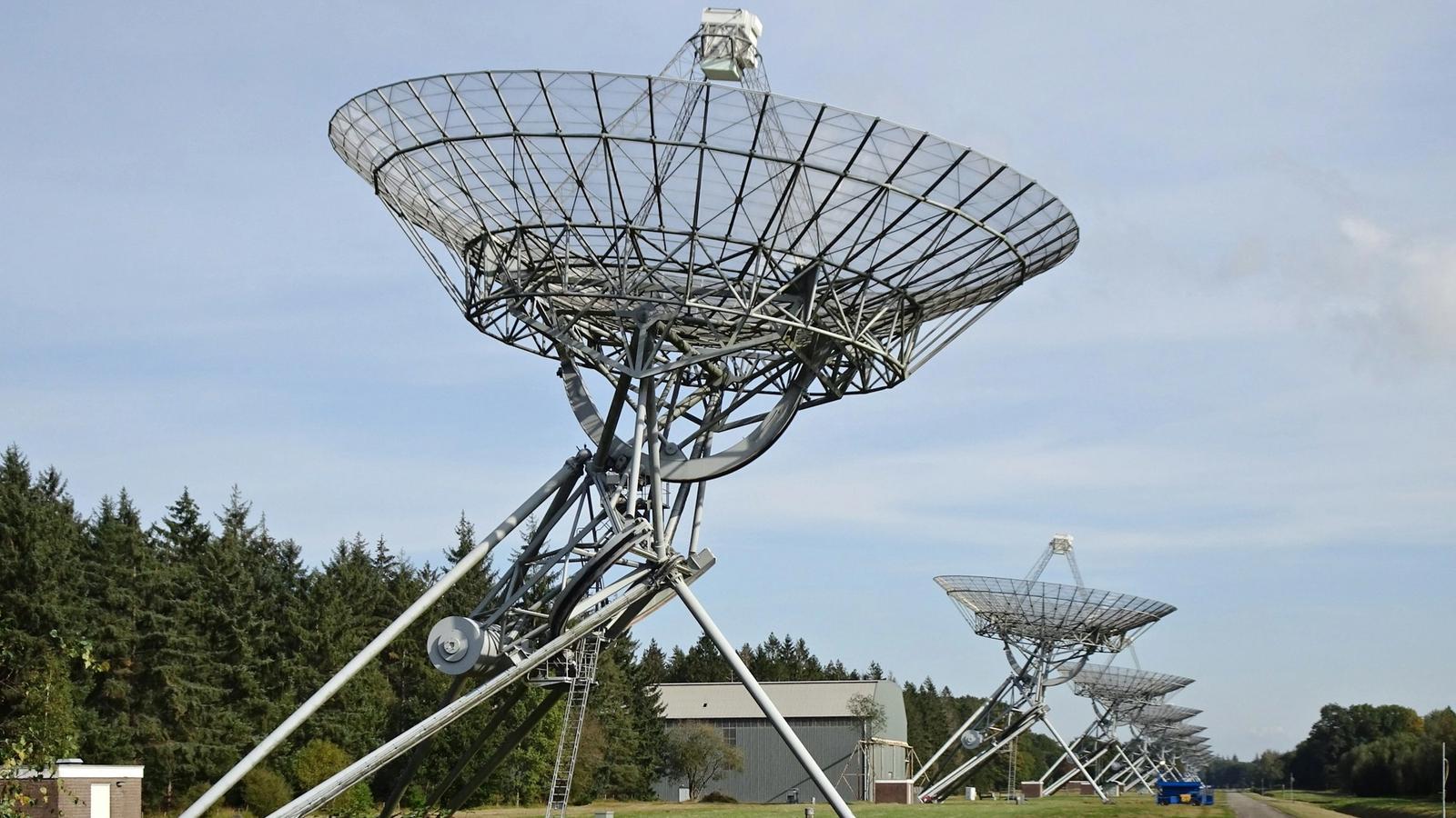 A line of European radio telescopes pointed toward the sky