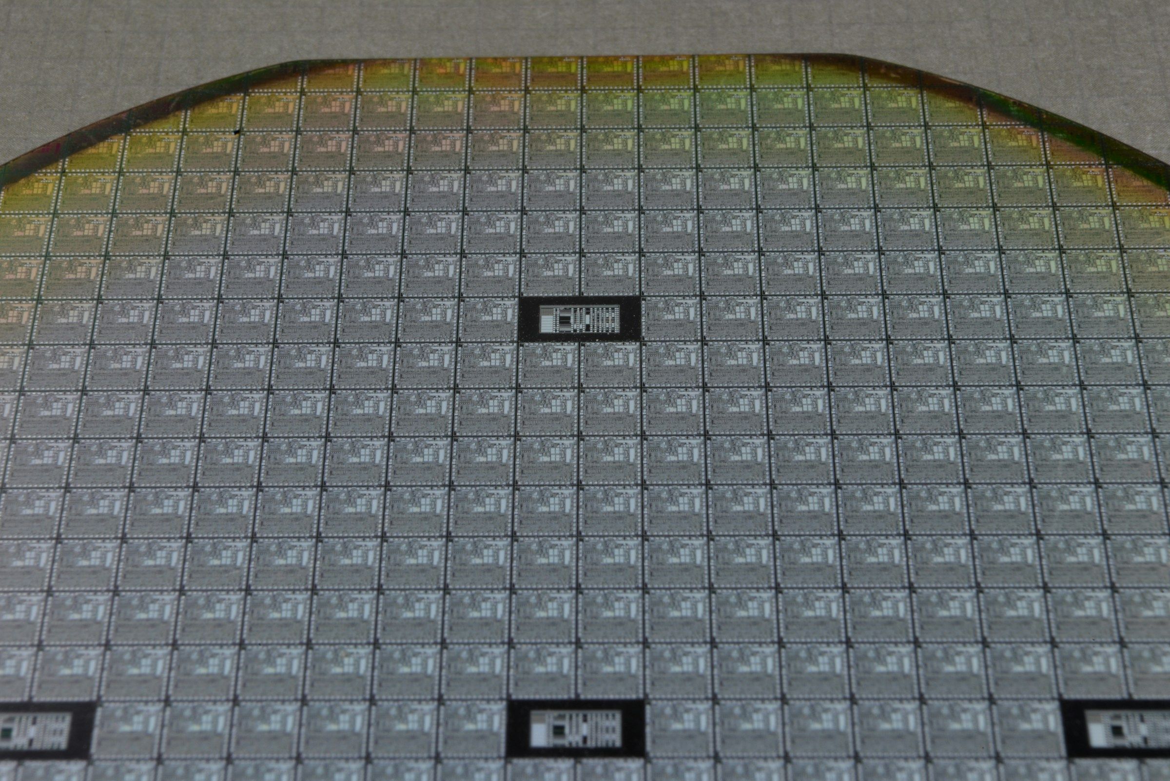 Macro view of a silicon wafer patterned with individual chip dies