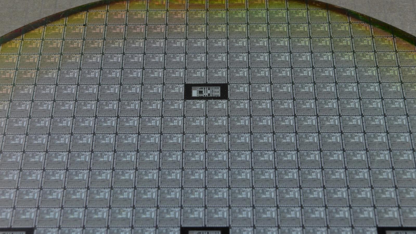 Macro view of a silicon wafer patterned with individual chip dies