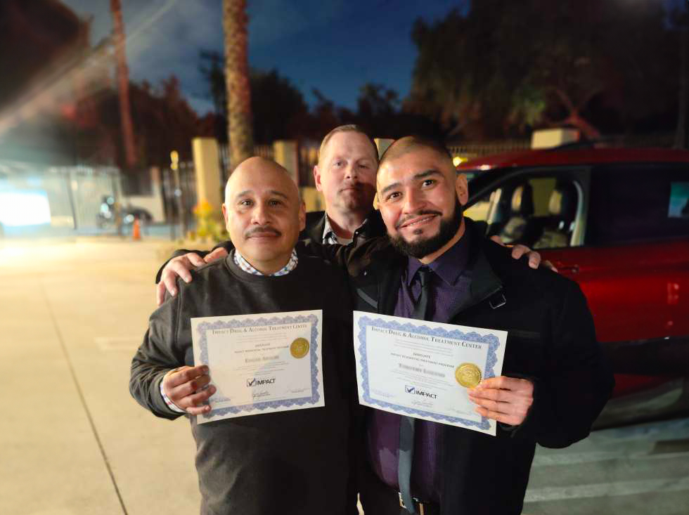 Program Manager David Moore with two graduates of Impact's PICS Group.