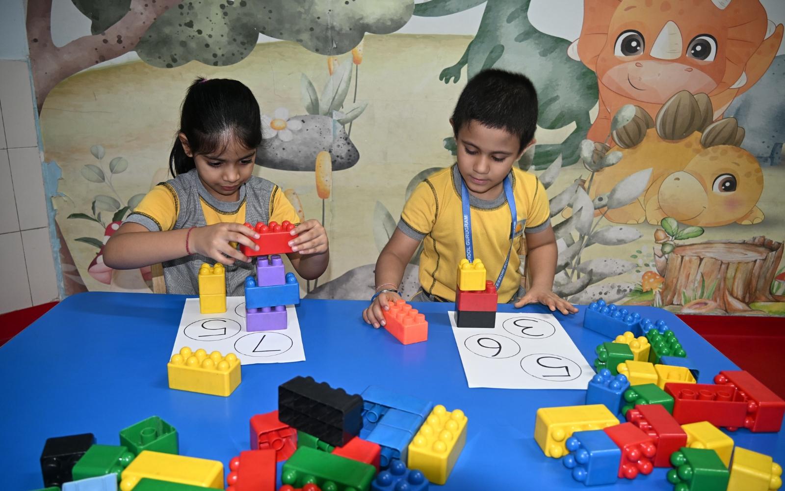Two children building models with colourful blocks