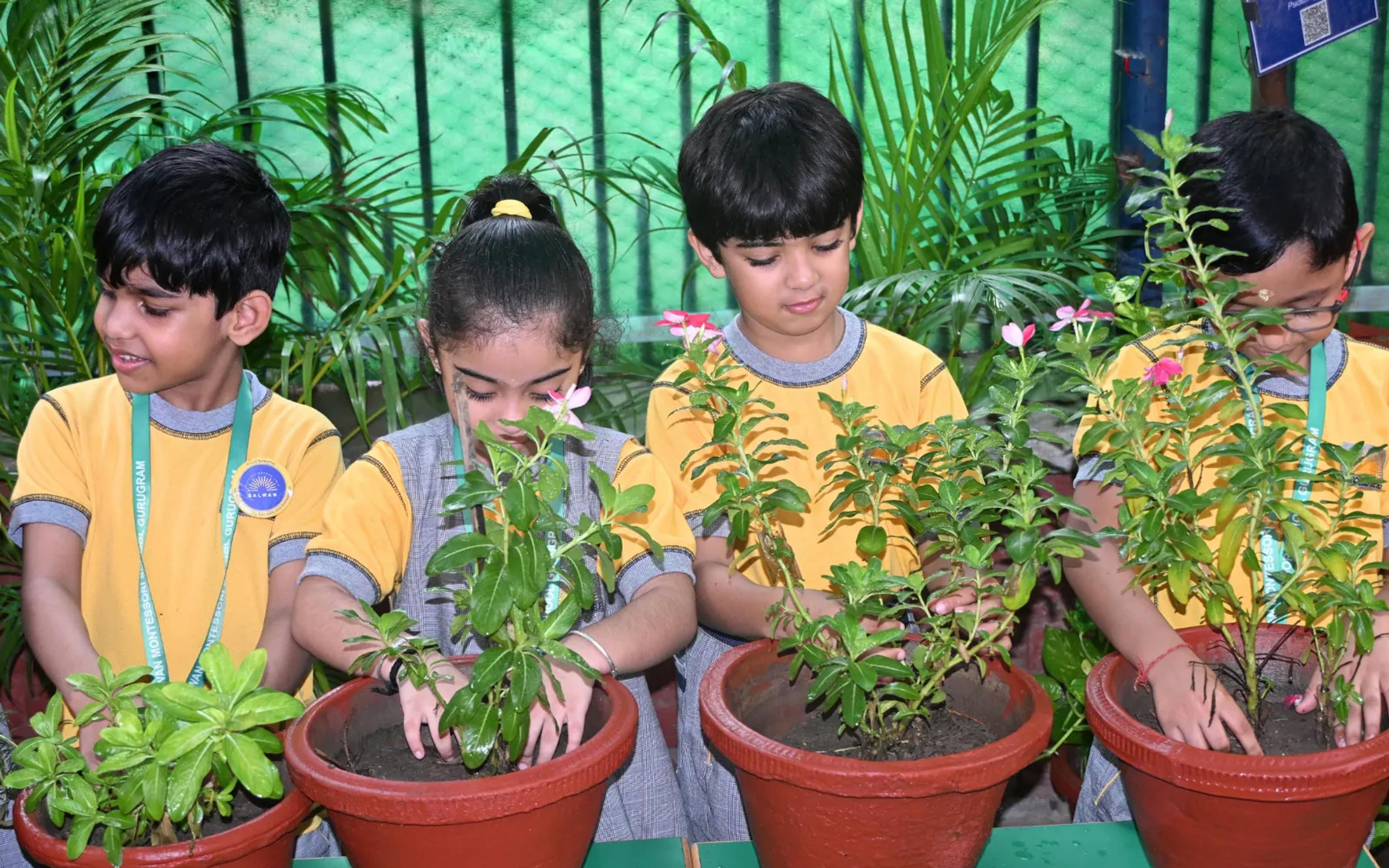 Young gardeners tending school plants