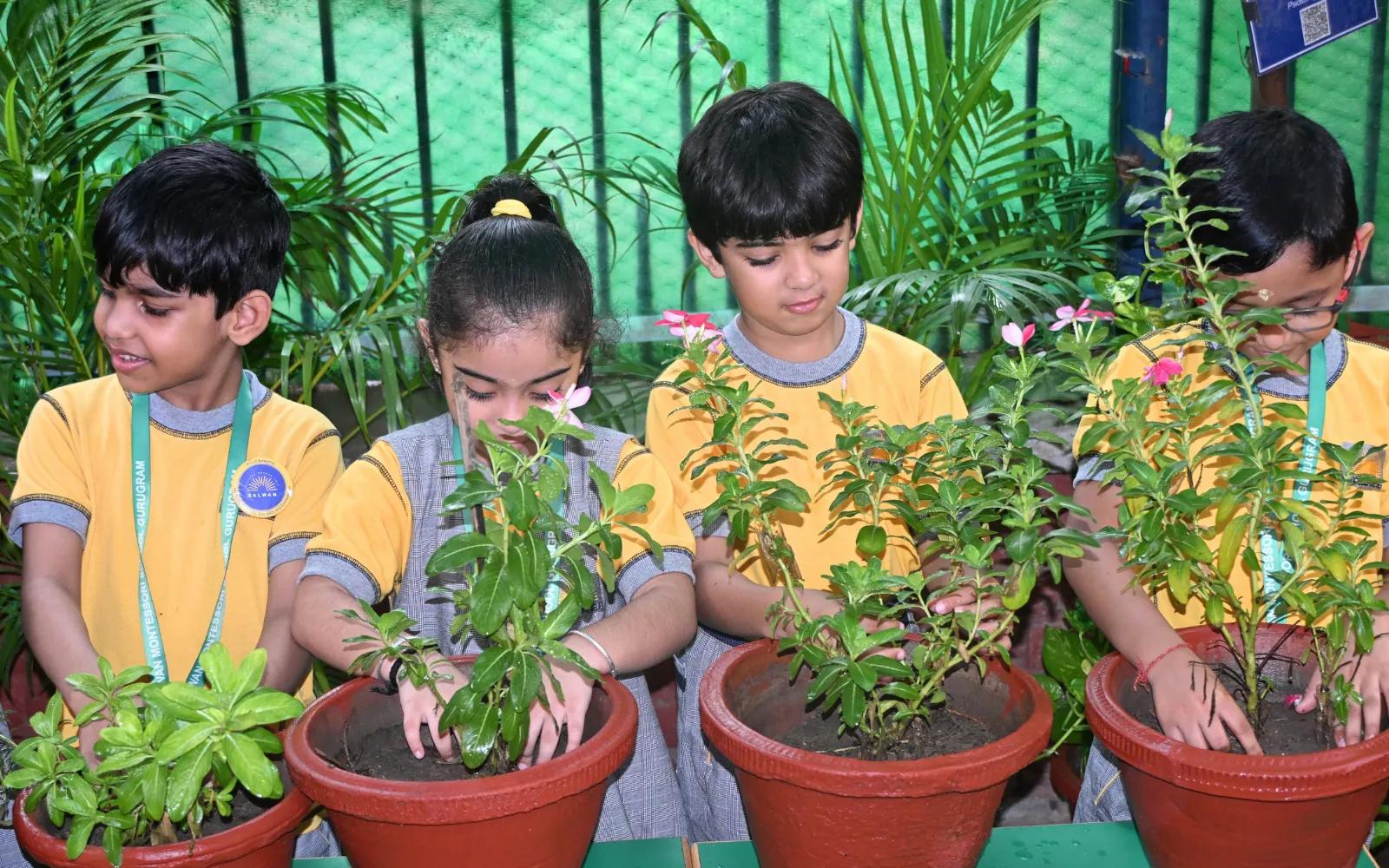 Young gardeners tending school plants