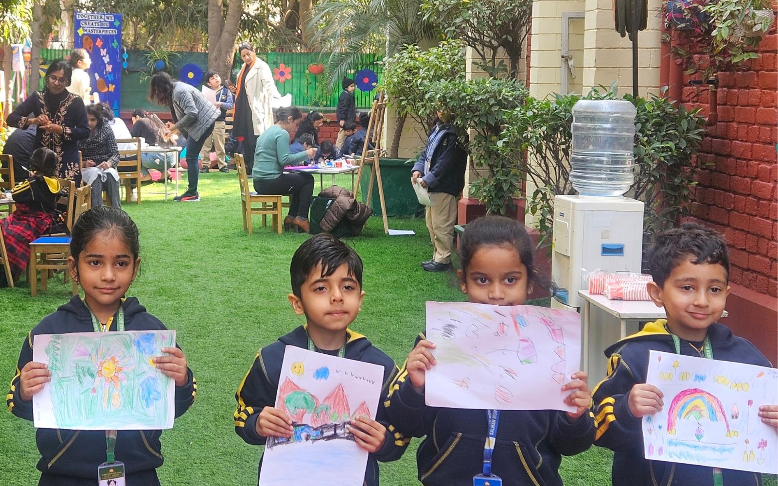 Children displaying their drawings during an outdoor showcase