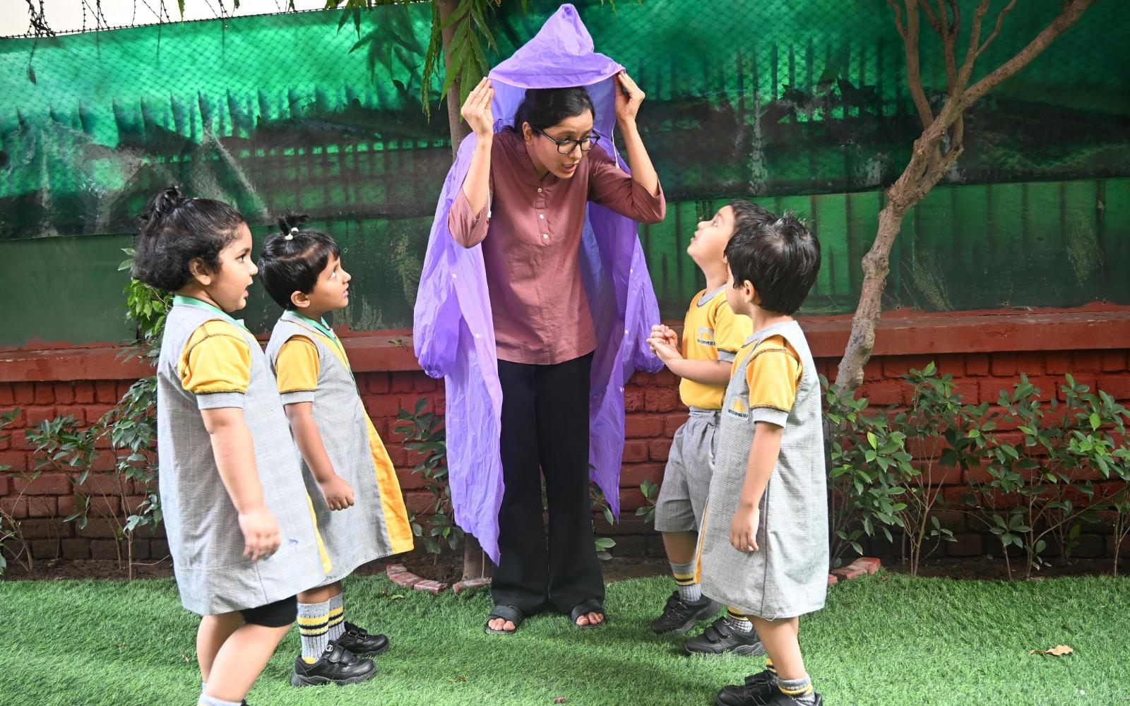 A teacher and children taking part in outdoor role-play