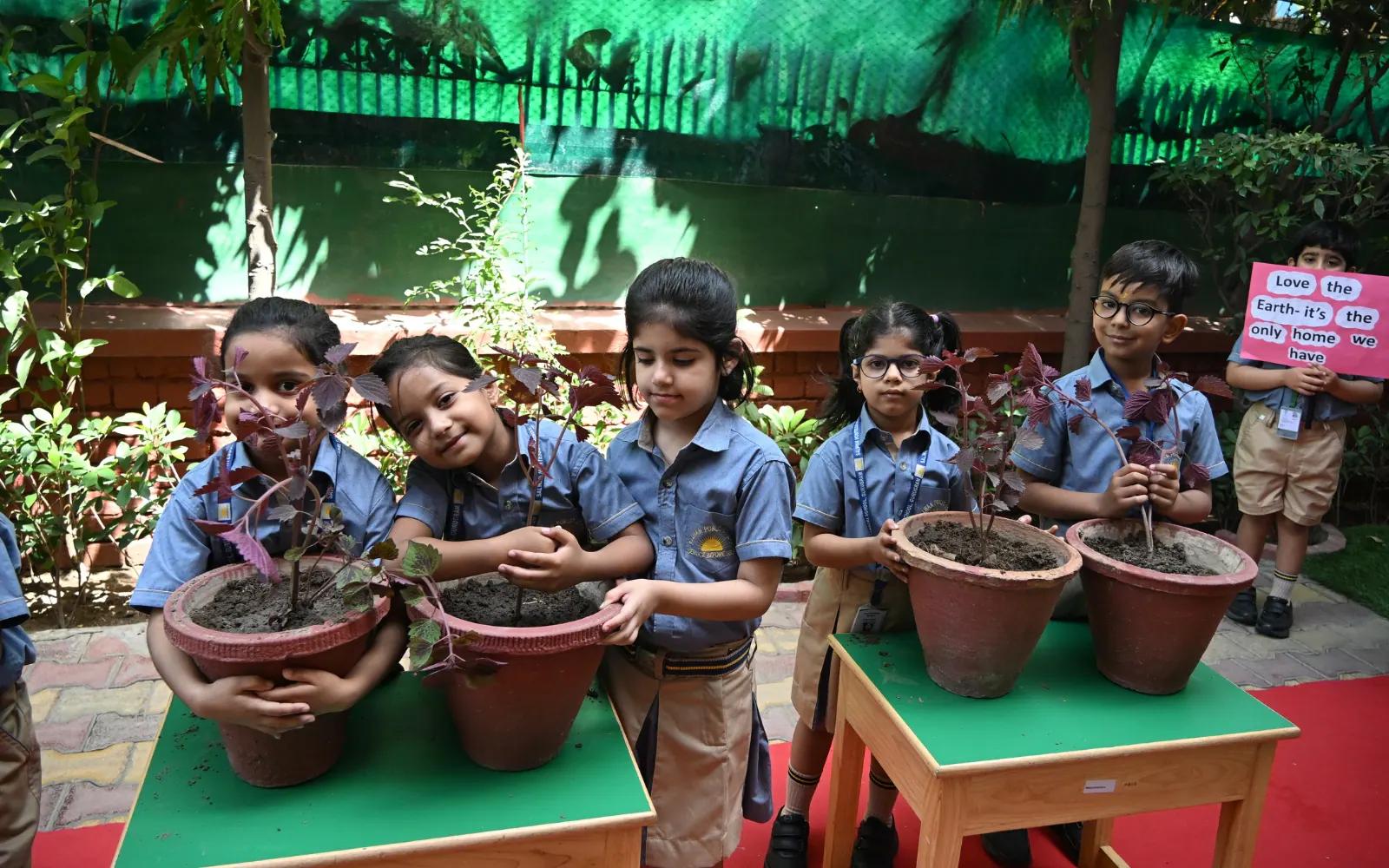 Children planting and caring for saplings