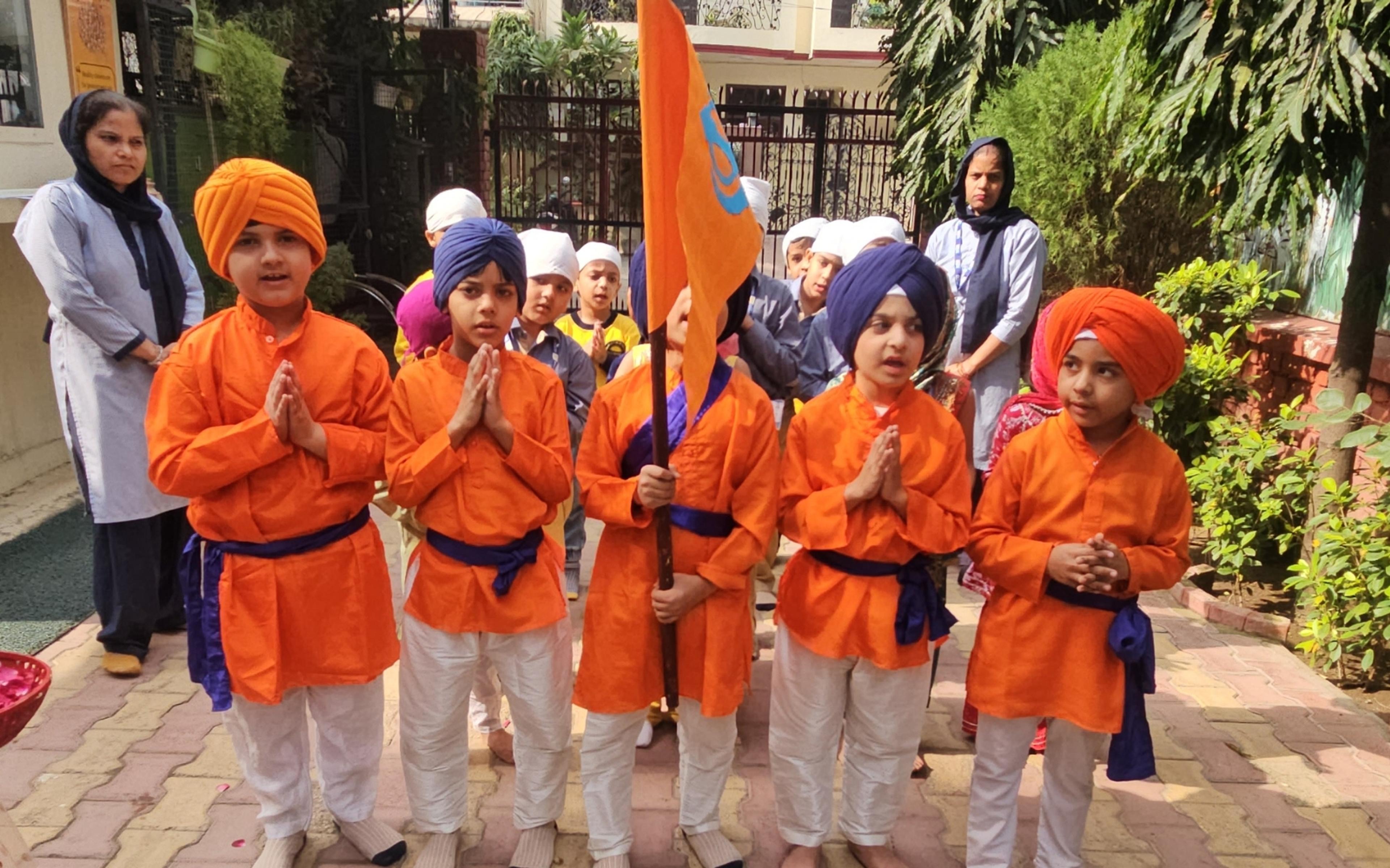 Children in Sikh attire during a cultural presentation