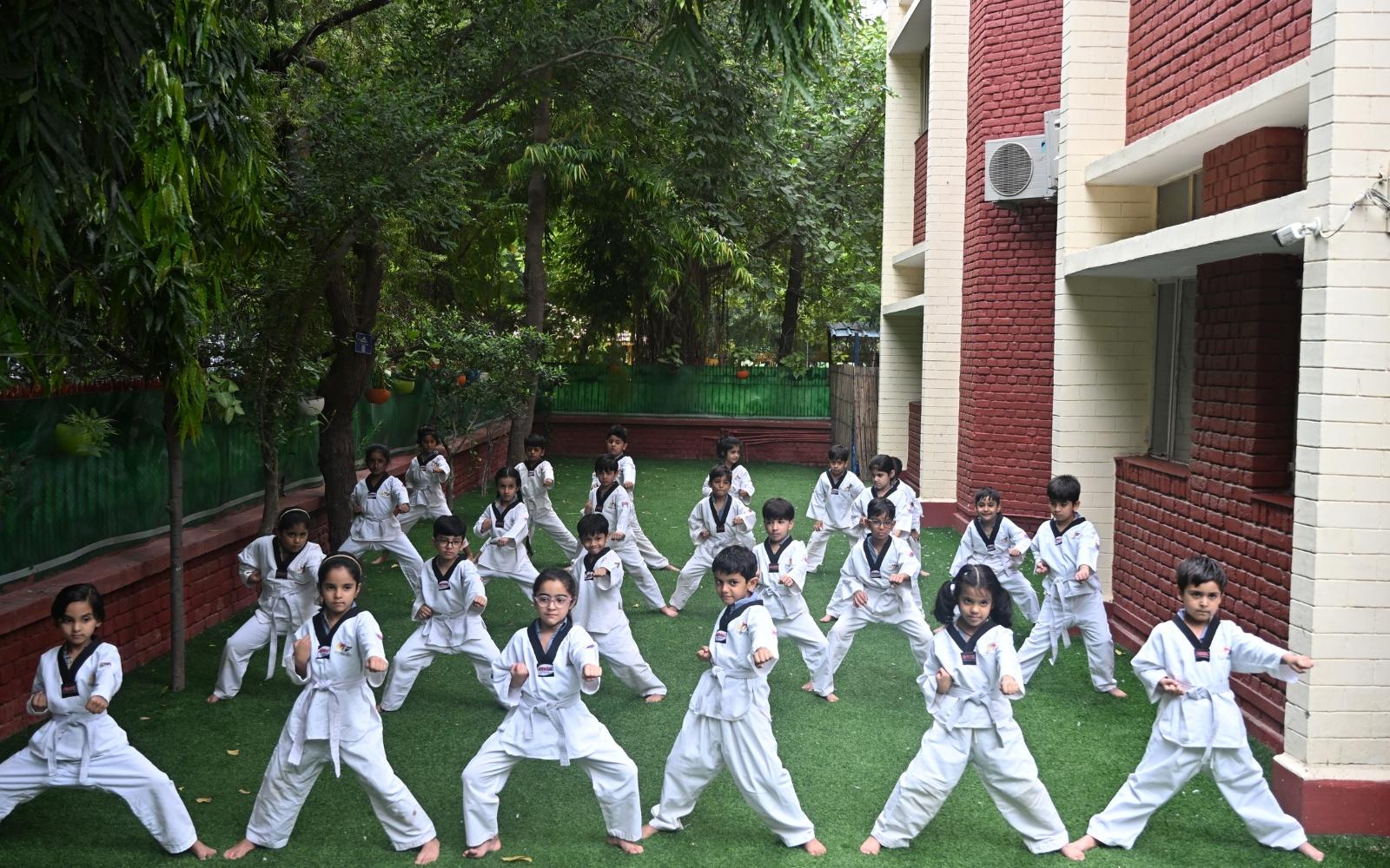 Students practising Taekwondo together outdoors