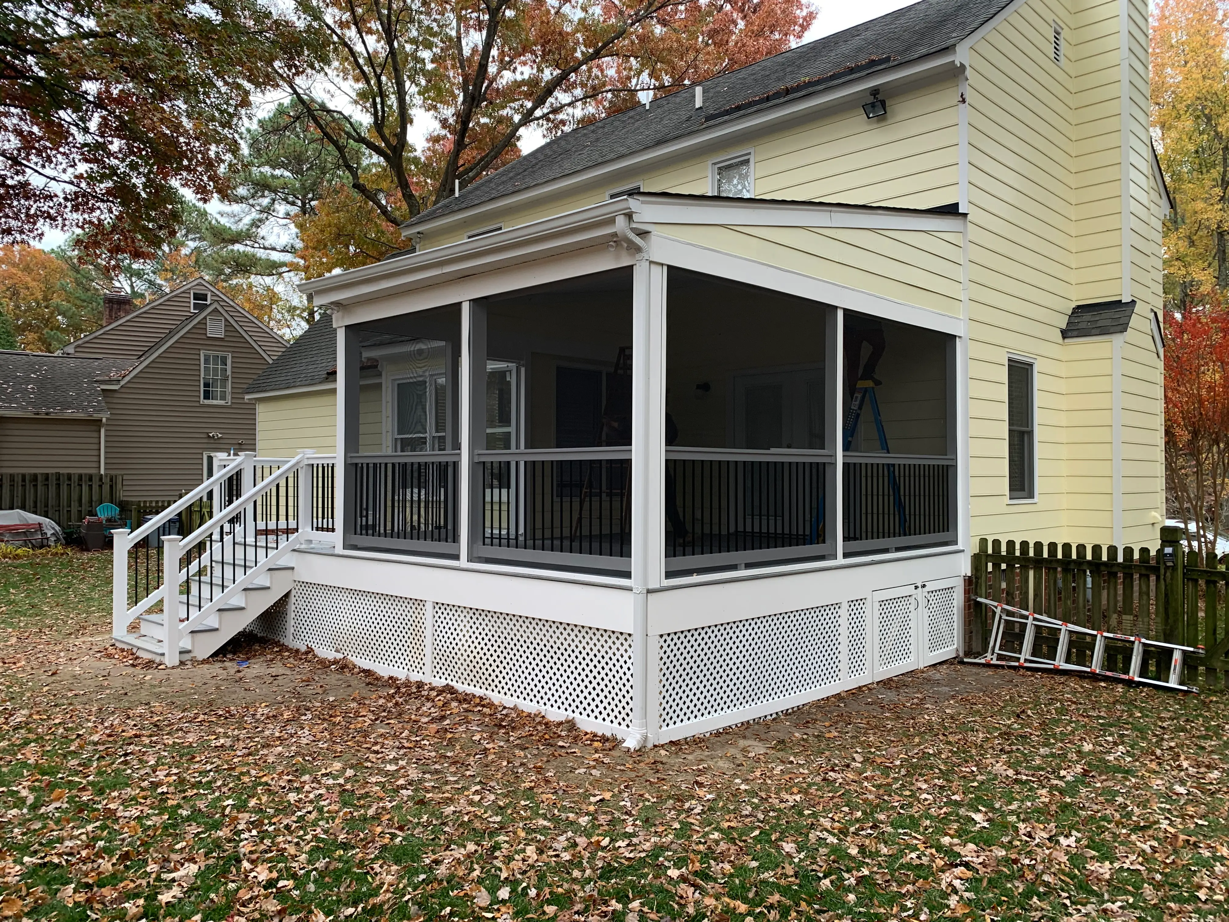 White screen porch and deck made of Trex Foggy Wharf and White Shoreline vinyl railings