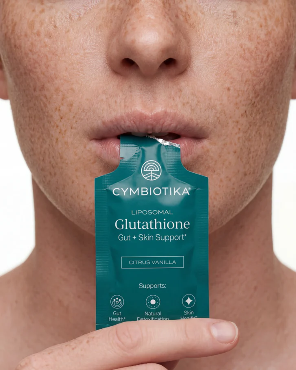 A person places a teal Cymbiotika Liposomal Glutathione citrus vanilla sachet into their mouth.