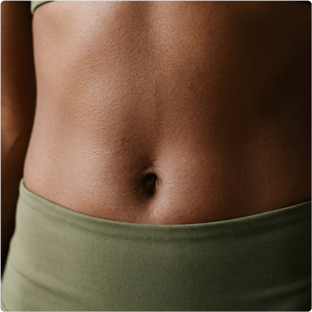 Close-up of a bare abdomen above a muted green waistband.