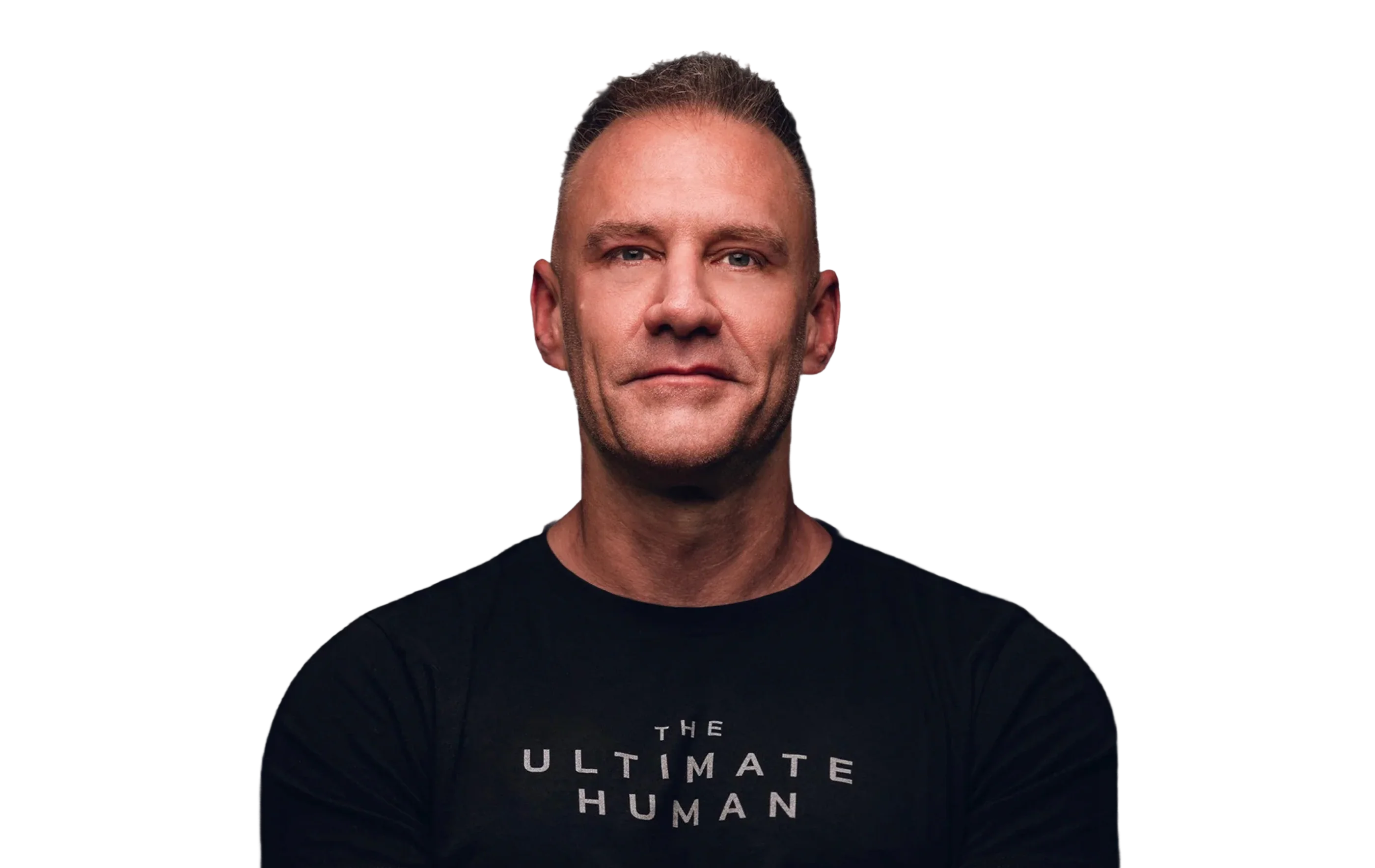 A man wearing a black shirt with “THE ULTIMATE HUMAN” lettering.