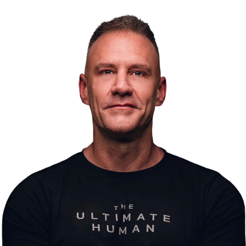 A man wearing a black shirt with “THE ULTIMATE HUMAN” lettering.