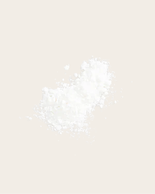 A small mound of fine white powder with scattered granules.