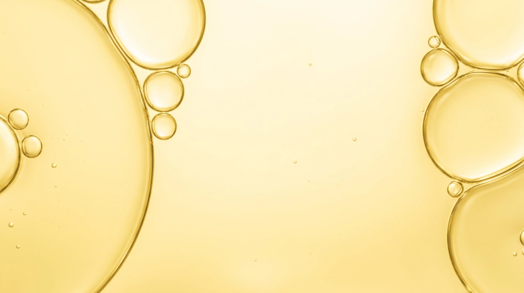 Large outlined golden-yellow circles and smaller bubble-like forms against a pale yellow background.