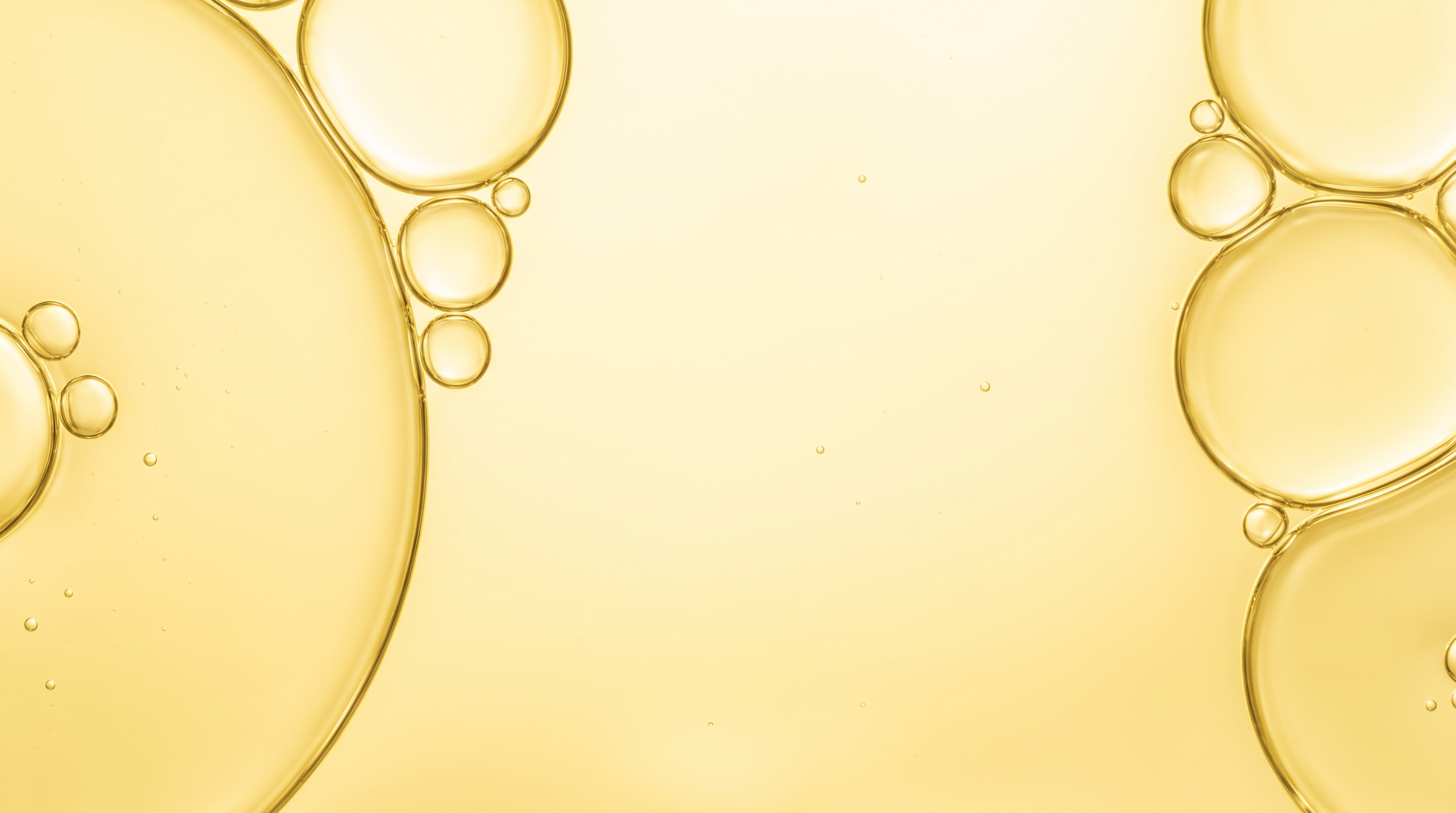 Large outlined golden-yellow circles and smaller bubble-like forms against a pale yellow background.