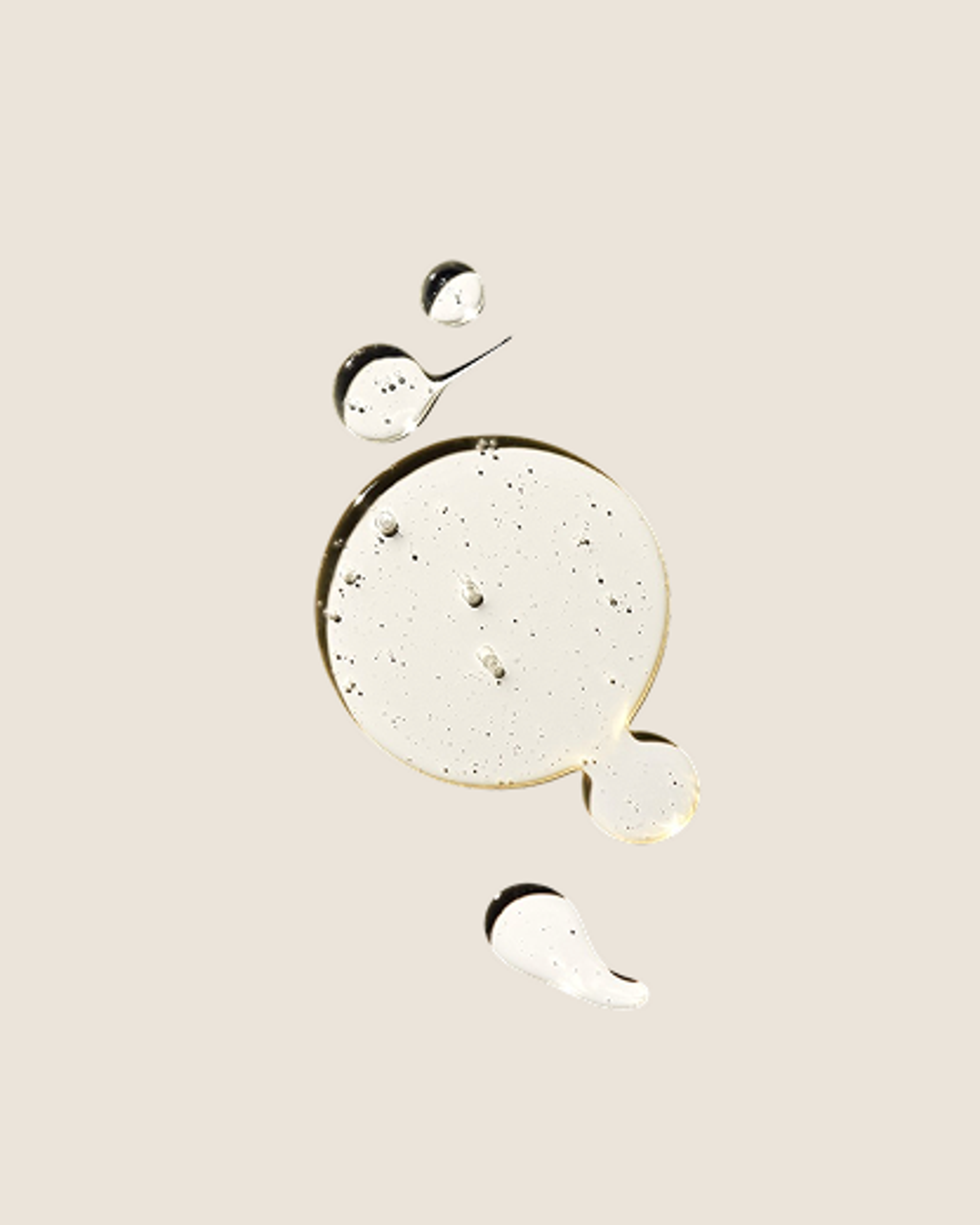 Pale translucent liquid forms with small suspended bubbles, including a large round pool and several droplets.