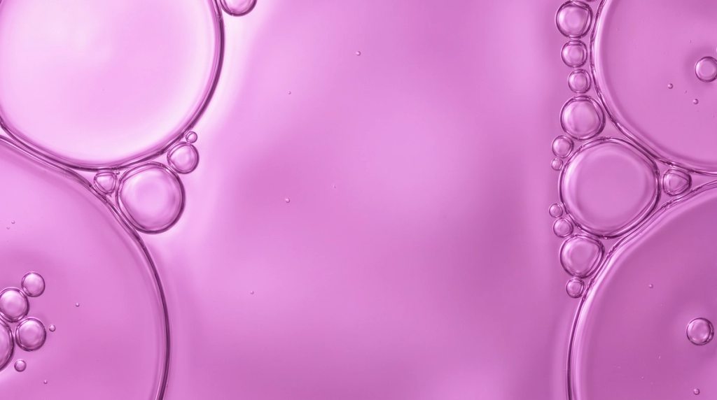 Close-up of pink liquid bubbles against a pink background, accompanying the Skin Health slide.