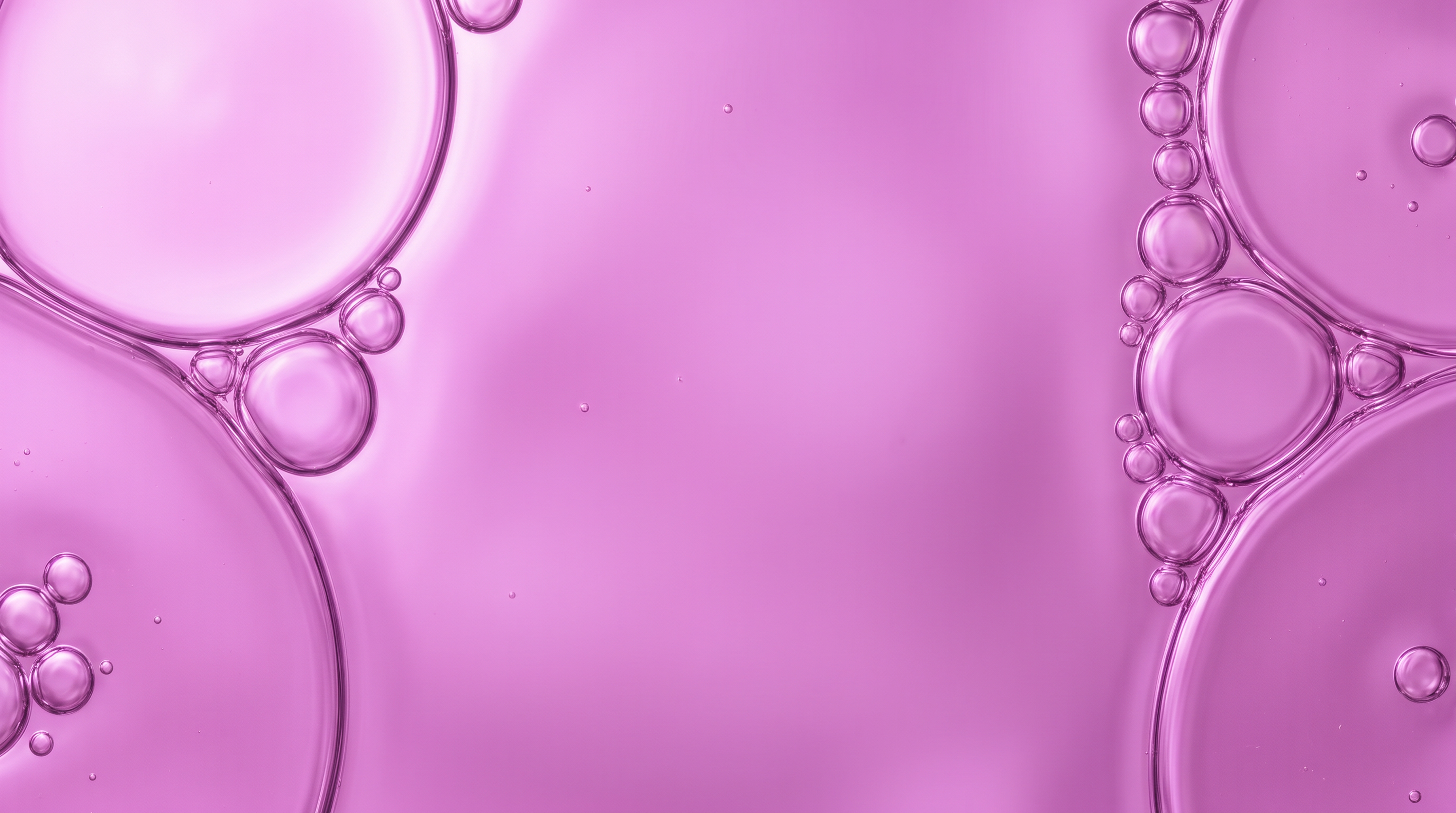 Close-up of pink liquid bubbles against a pink background, accompanying the Skin Health slide.
