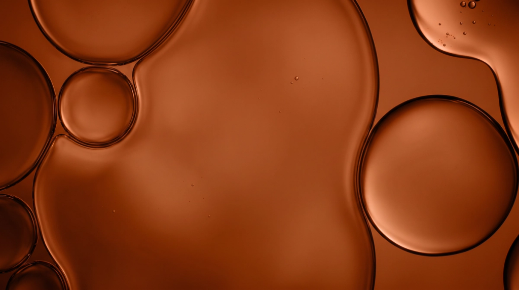 Abstract close-up of amber-colored liquid bubbles, used as a visual for the Immunity supplement tab.