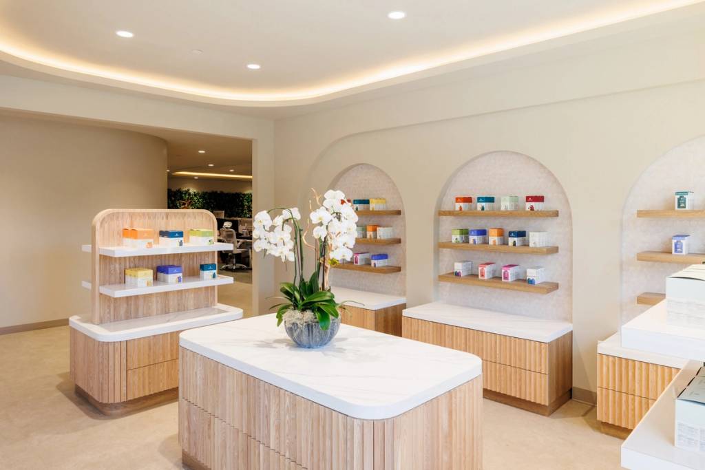 Product showroom with Cymbiotika products on arched shelves