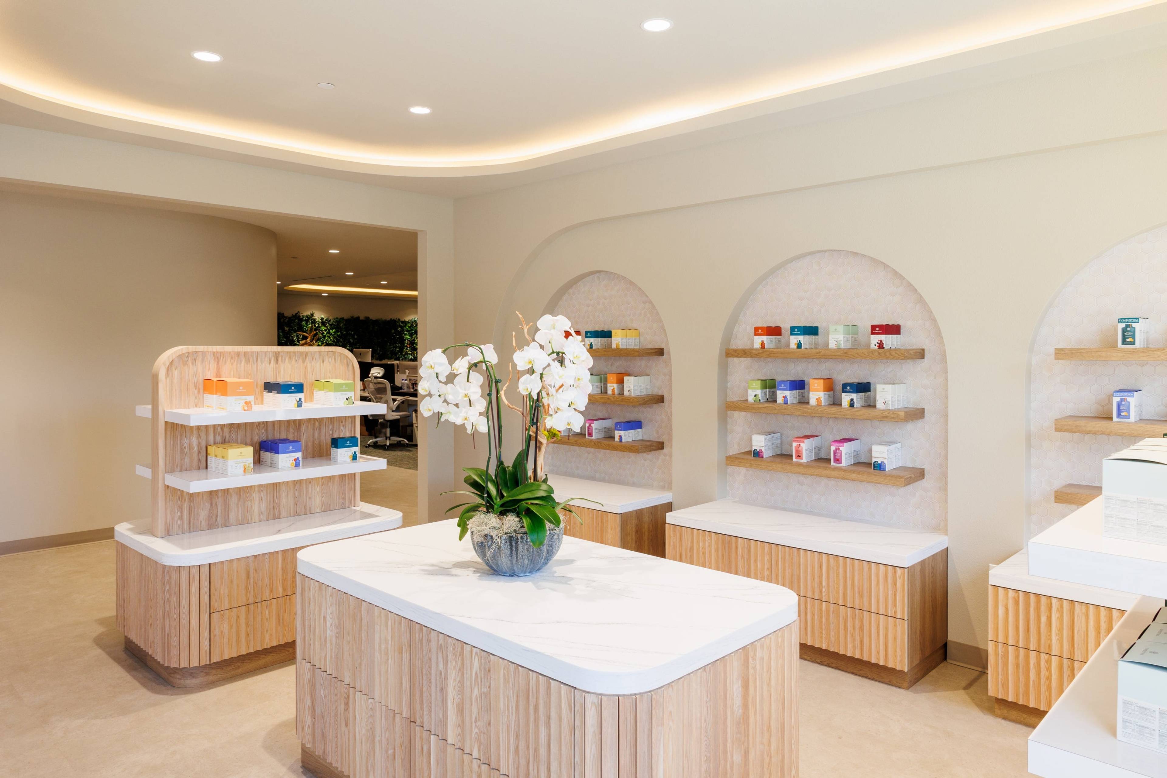 Product showroom with Cymbiotika products on arched shelves