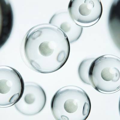 Rounded translucent forms with textured spheres at their centers, illustrating the absorption statistic.