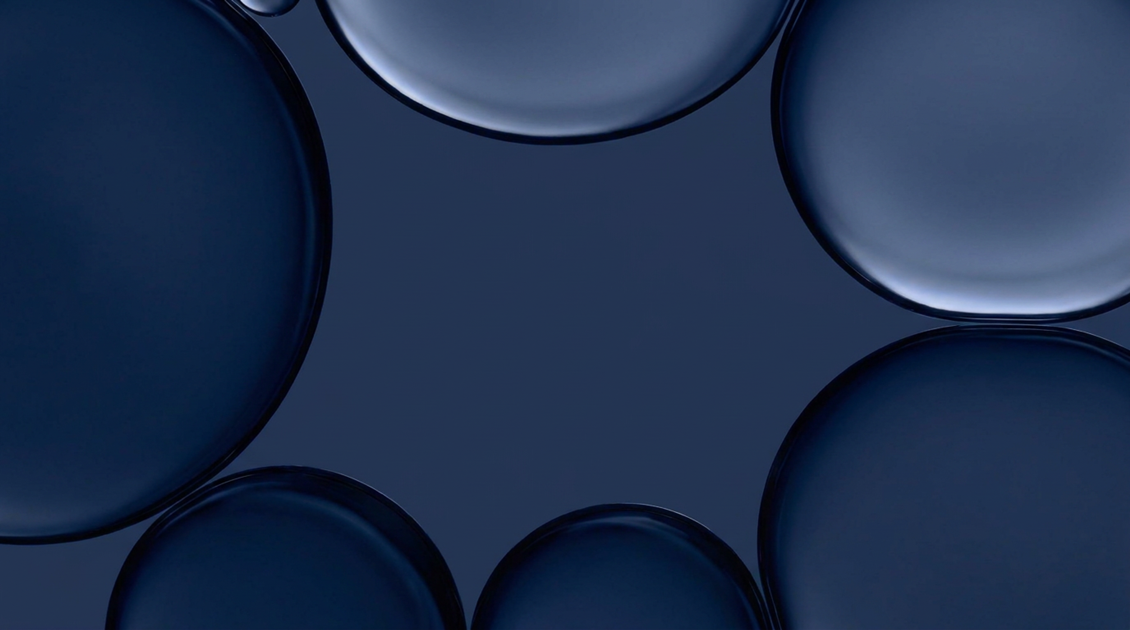 Overlapping dark blue, rounded bubble-like forms in an abstract illustration.