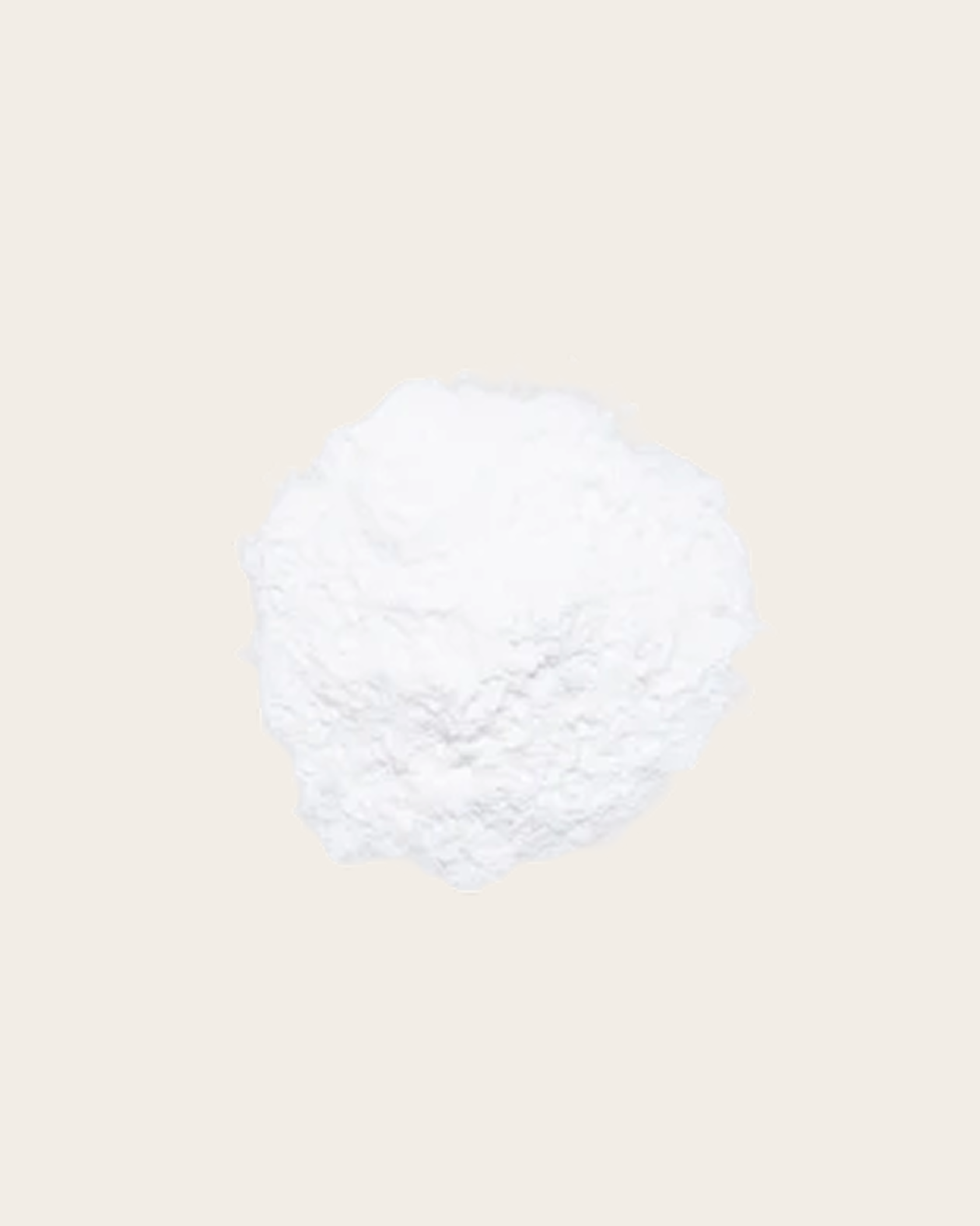 White, rough-textured irregular mound against a pale beige background, illustrating an ingredient.