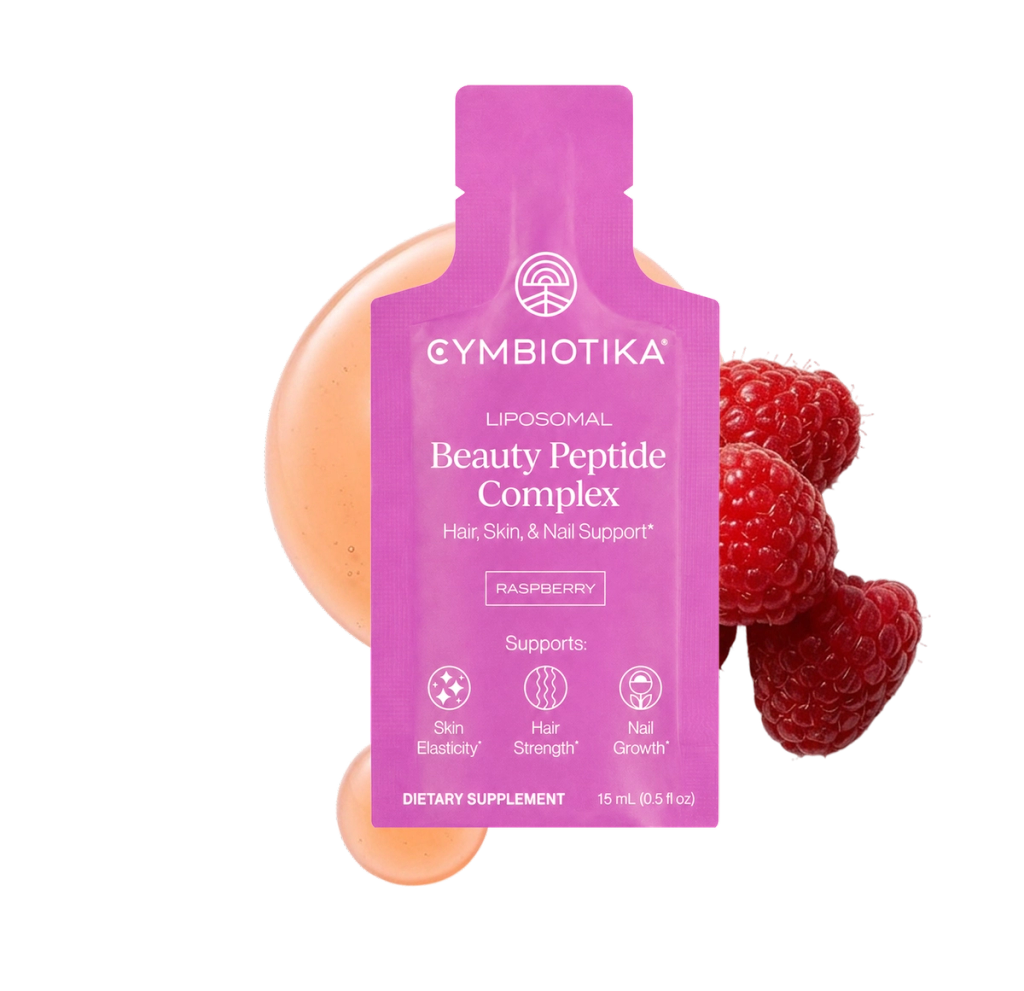 Pink Cymbiotika Liposomal Beauty Peptide Complex sachet with raspberries and peach-colored fruit behind it.