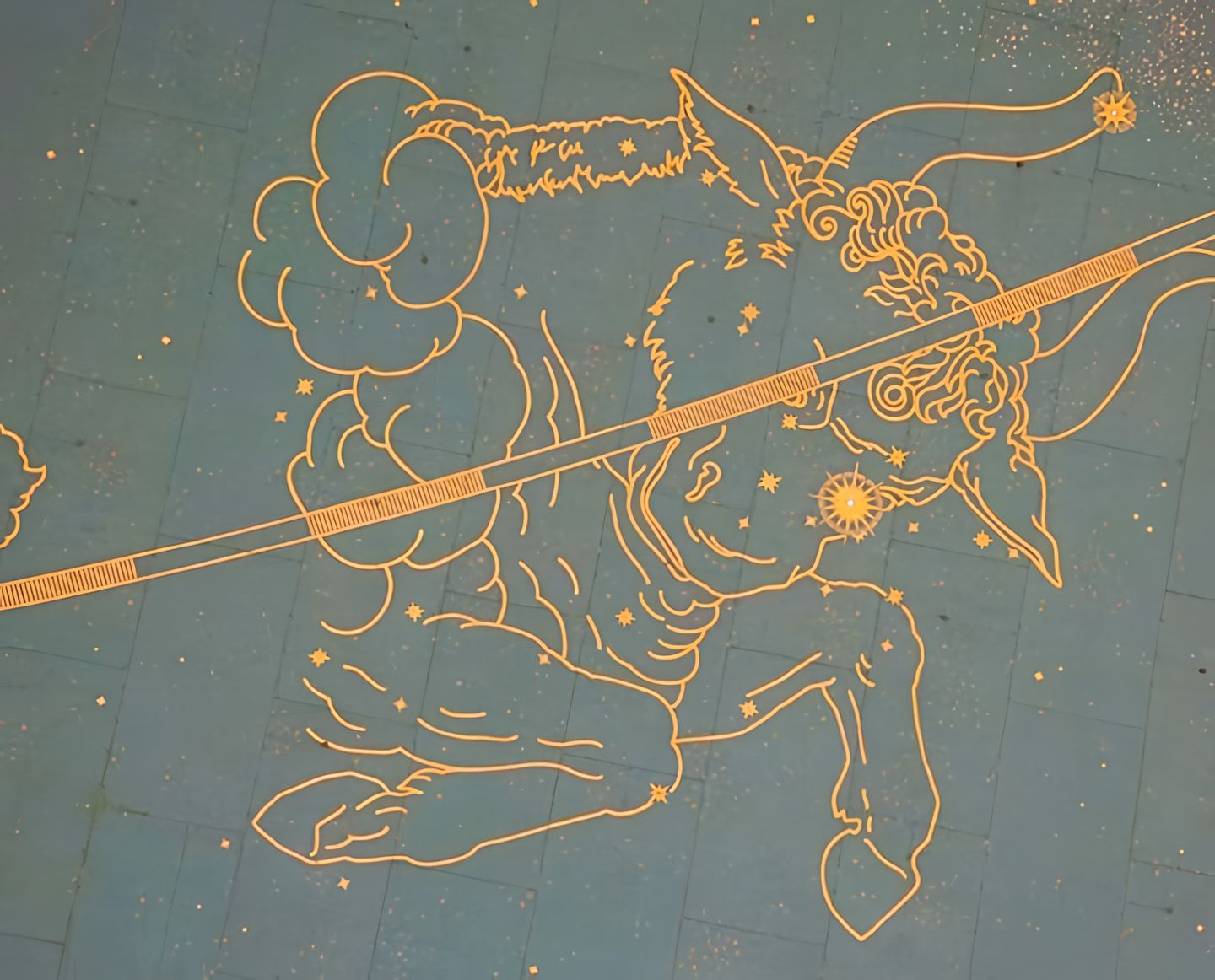 Gold line illustration of a centaur drawing a bow against a speckled teal, starry background.