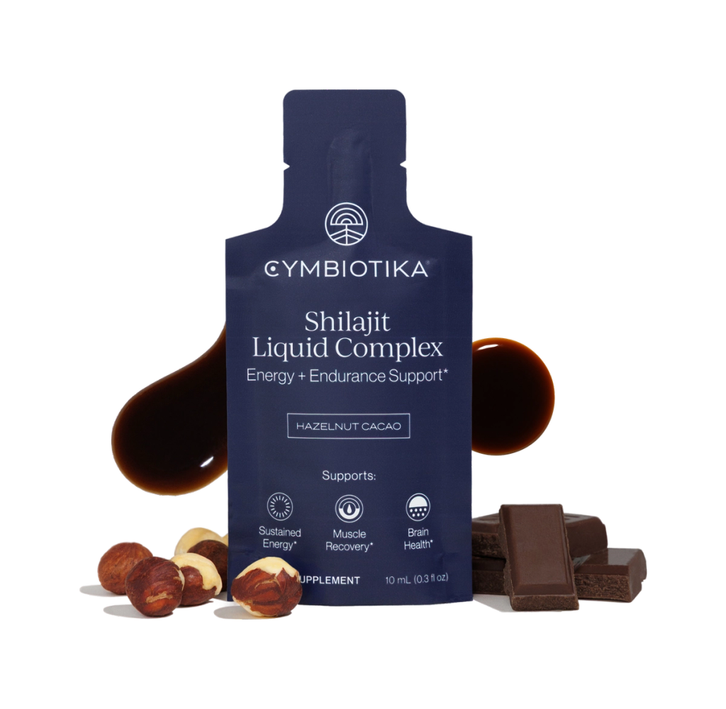 Shilajit Liquid Complex bottle with hazelnuts, cacao pieces, and a dark liquid drop; label reads “Hazelnut Cacao.”