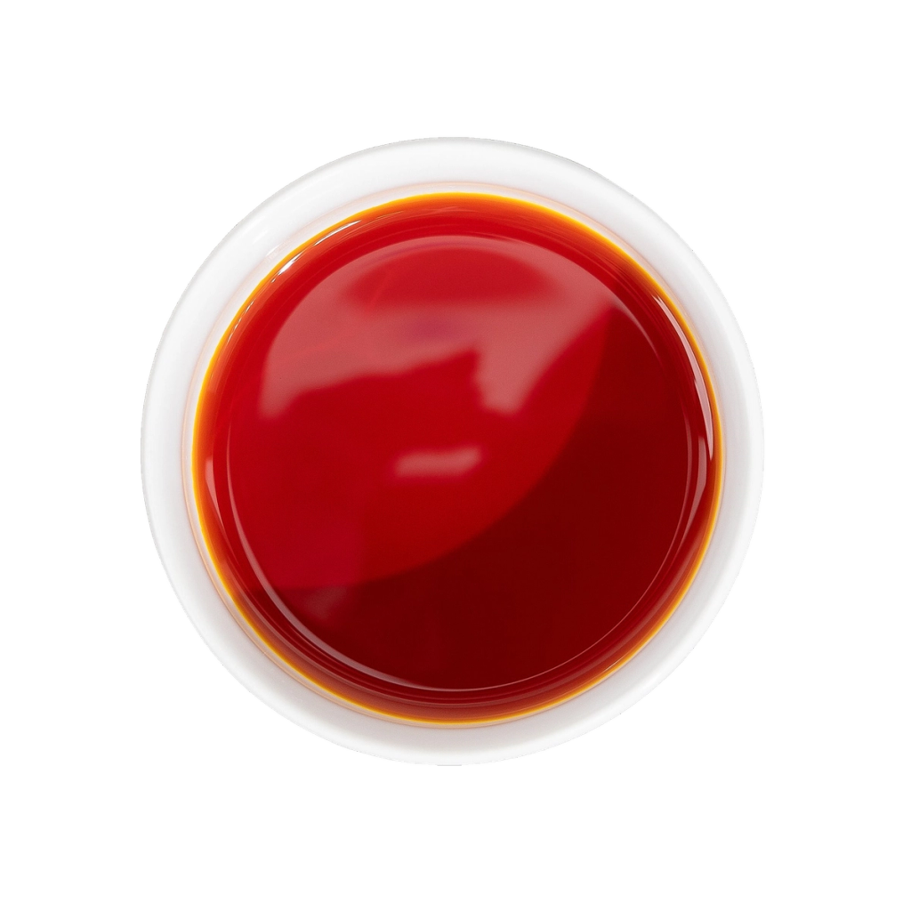 A round dish of deep red liquid viewed from above, illustrating an ingredient.