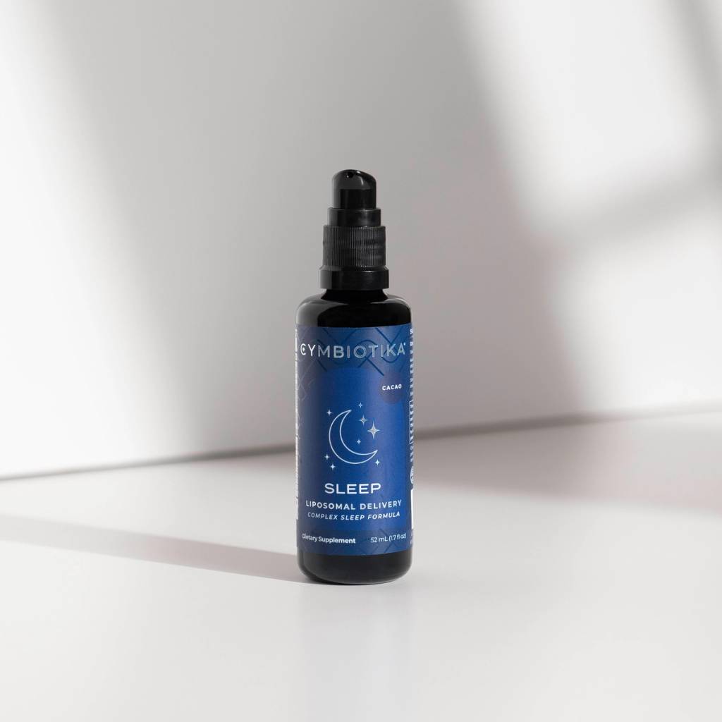 Blue-labeled pump bottle marked “SLEEP” standing on a white surface.