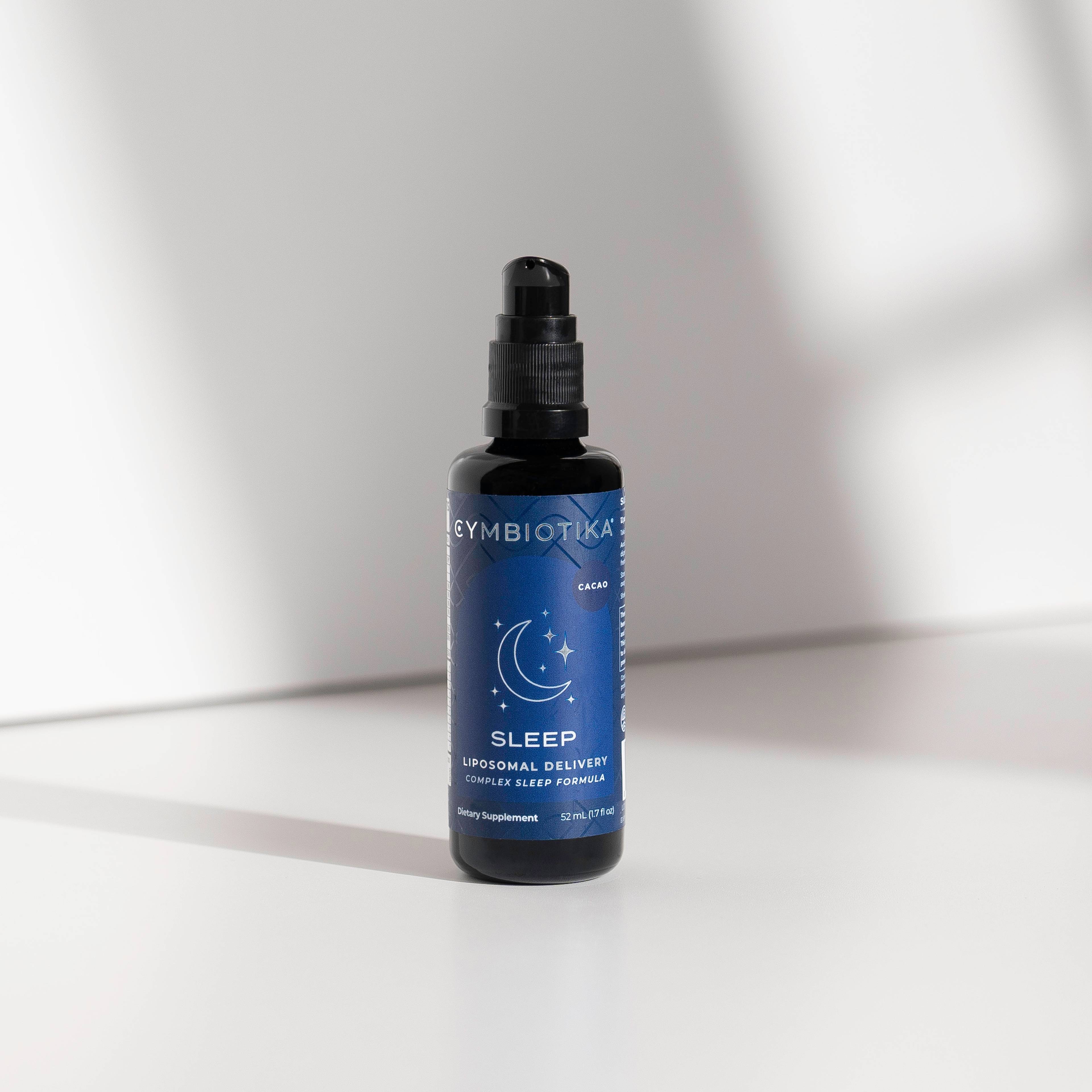 Blue-labeled pump bottle marked “SLEEP” standing on a white surface.