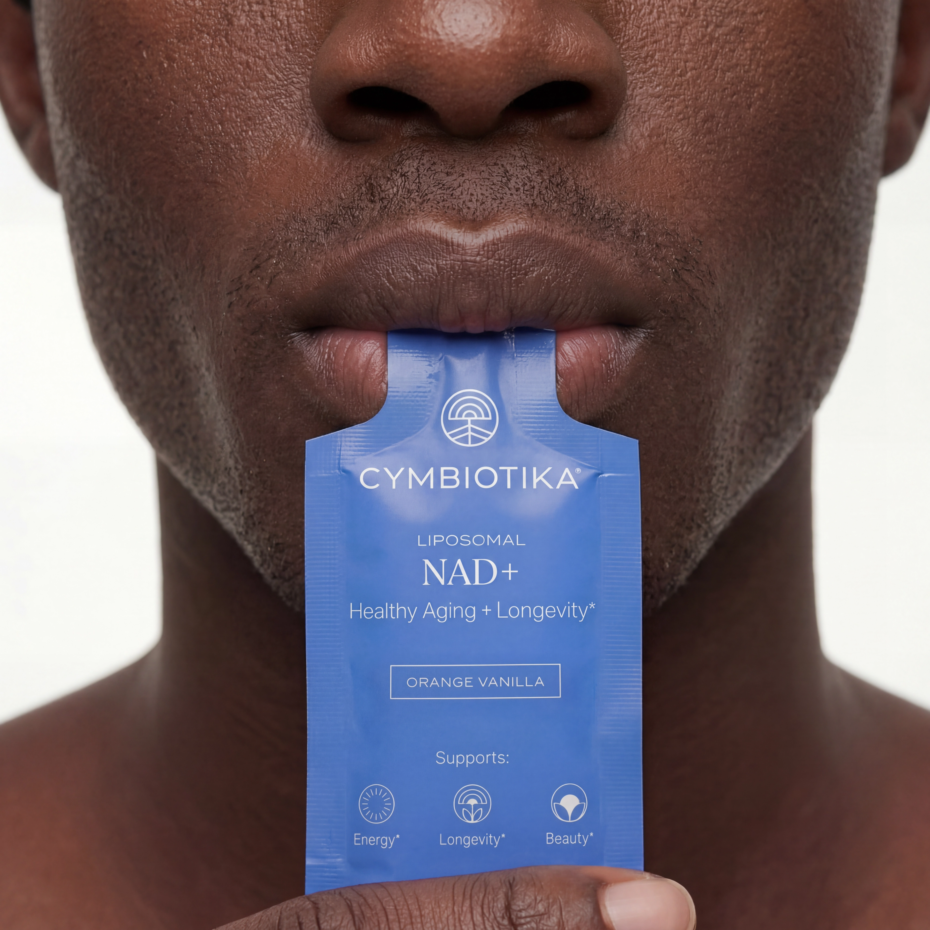 Person holds a blue Cymbiotika Liposomal NAD+ packet between their lips, demonstrating the single-serve packet.
