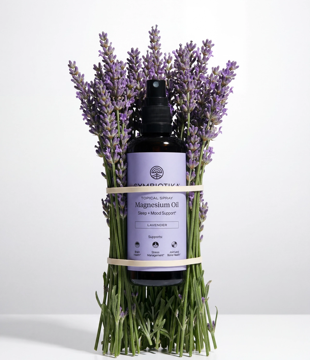 Topical Magnesium Oil Spray bottle nestled among lavender sprigs.